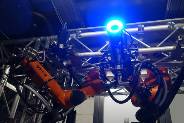 Two inverted robots with blue vision system light 